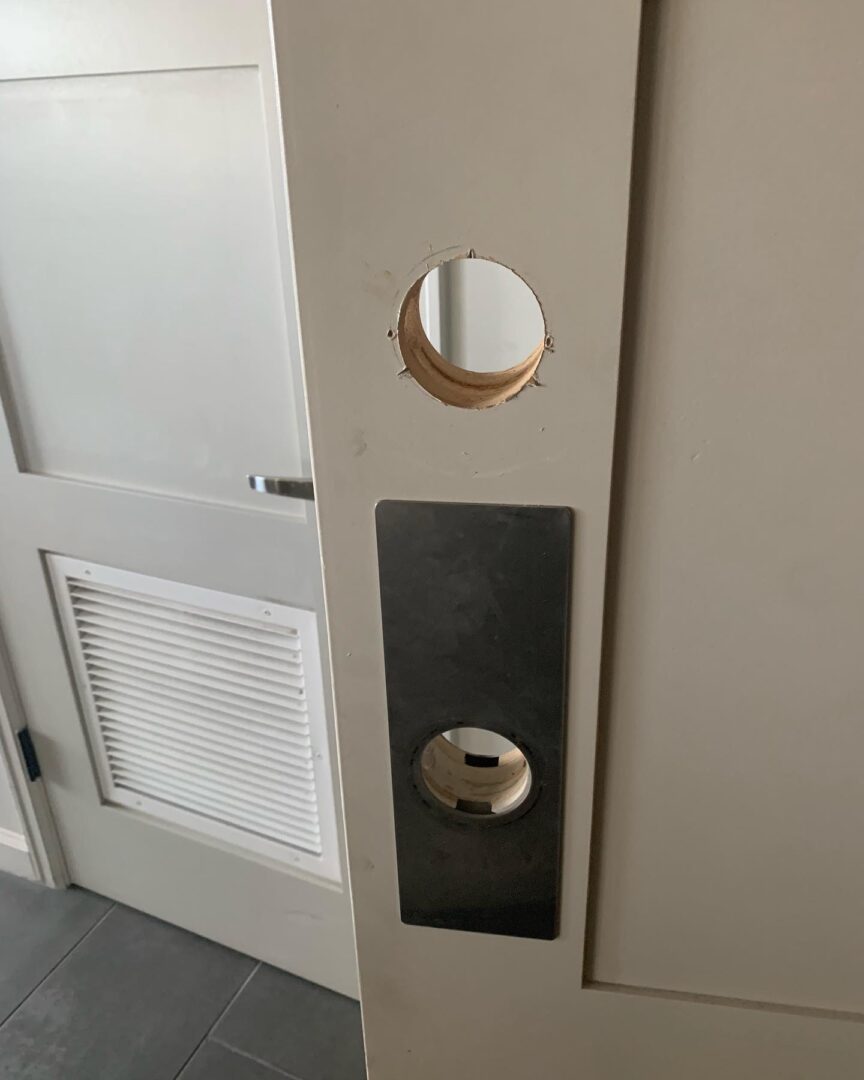 A door with two round holes in it.