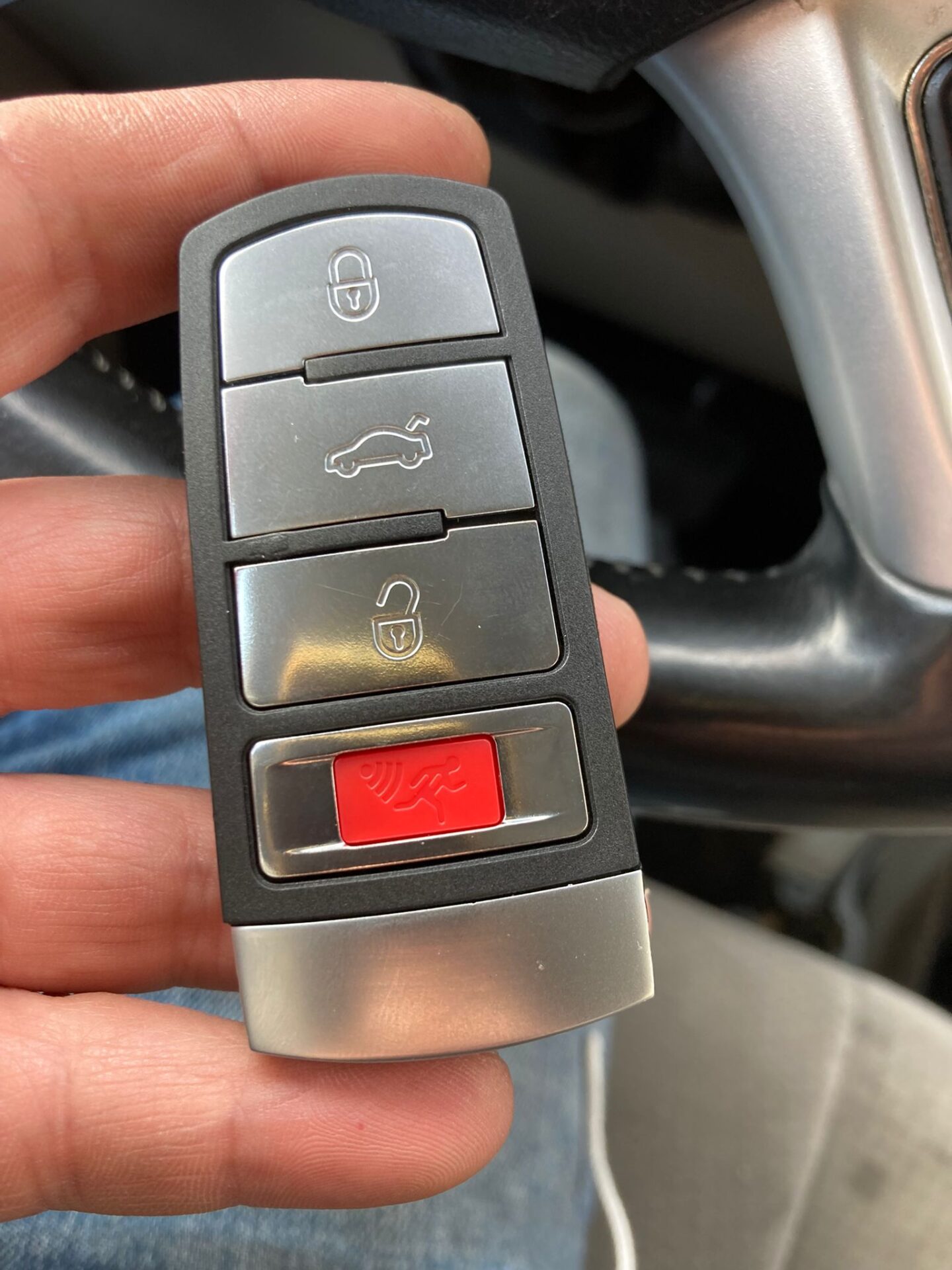 A person holding a car key in their hand.